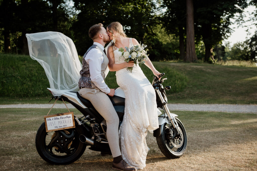 Wedding couple kissing on a motorbike