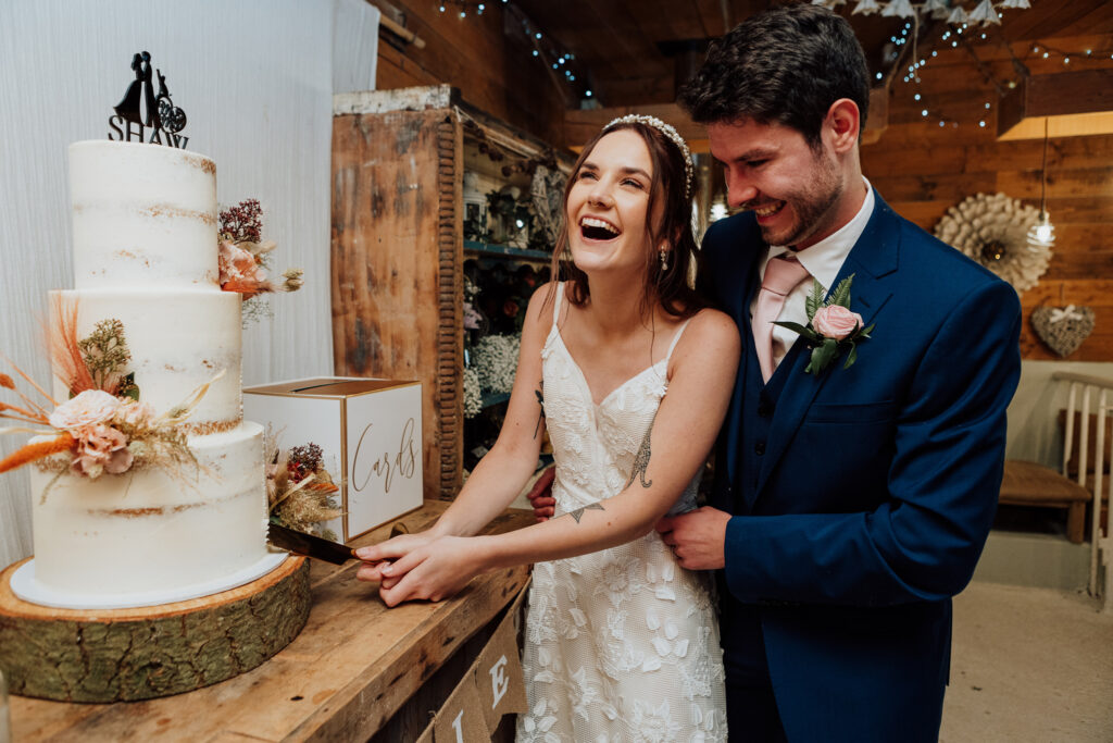 Wedding Photography: Happy male and female couple cutting cake